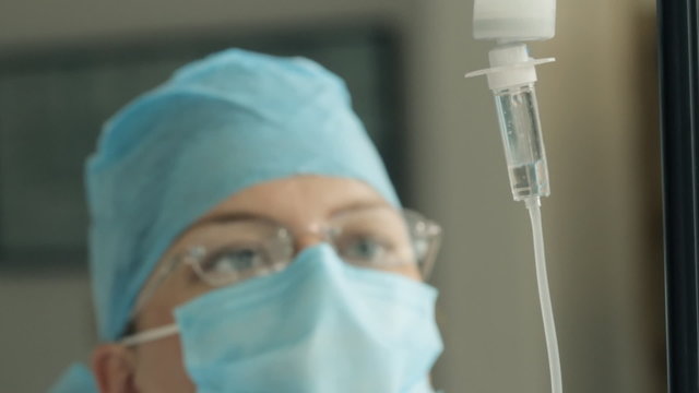 Doctor Adjusting IV Drip