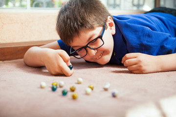Little boy playing with marbles at home © AntonioDiaz