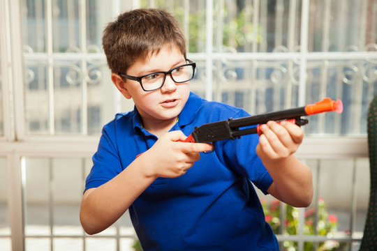 Kid Shooting A Toy Gun