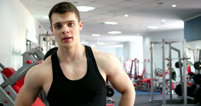 Young sports man in gym portrait