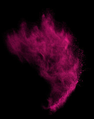 Freeze motion of pink dust explosion isolated on black