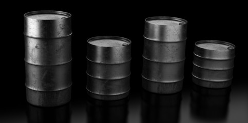 Four oil barrels on dark background