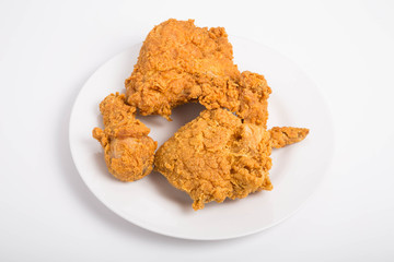 Four Pieces of Fried Chicken on White Plate and Counter