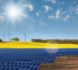 Solar power cells, rapeseed field and windmills