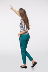 Back view of full length business woman in pointing at copy spac