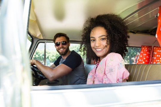 Hipster Couple Driving In Camper Van