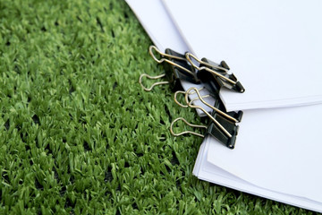 black paper cliping on paper pad on turf