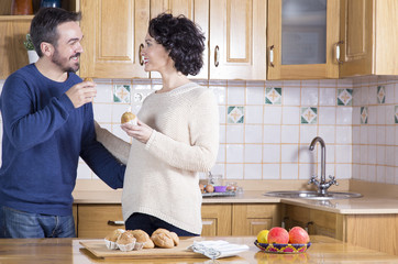 Man and woman eating homemade cupcakes