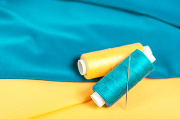 Colored threads and needles on textile