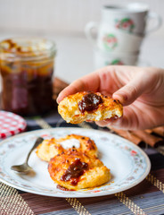 cottage cheese pancakes with caramel on a white background, hand