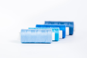 Threads of blue shades on a white background