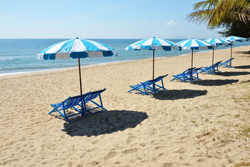blue and white canvas bed on the beach