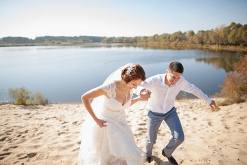 bride and groom, kissing on a beach