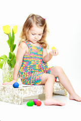 Little curly girl with Easter eggs