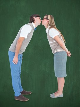 Composite image of geeky hipster couple kissing