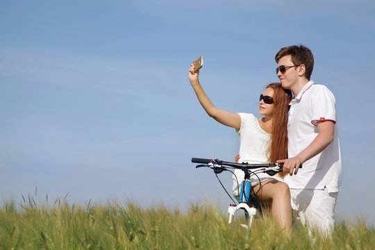 Couple on a bicycle in a field