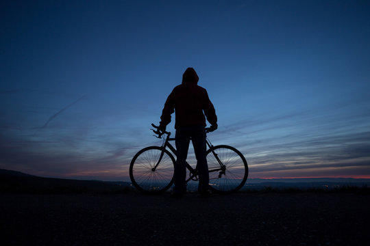 silhouetted cyclist