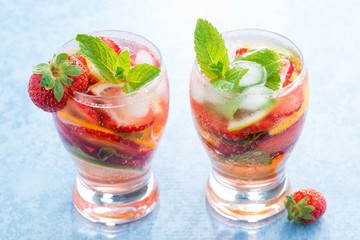 cocktail with fresh strawberries and citrus in glasses