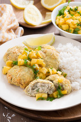 fish cakes with mango salsa and rice, vertical