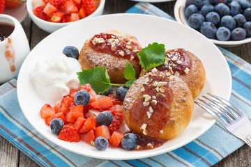 sweet cheese pancakes with berries and cream, top view