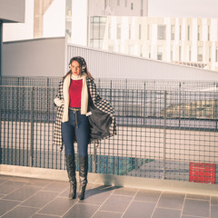 Beautiful young brunette posing in the city streets