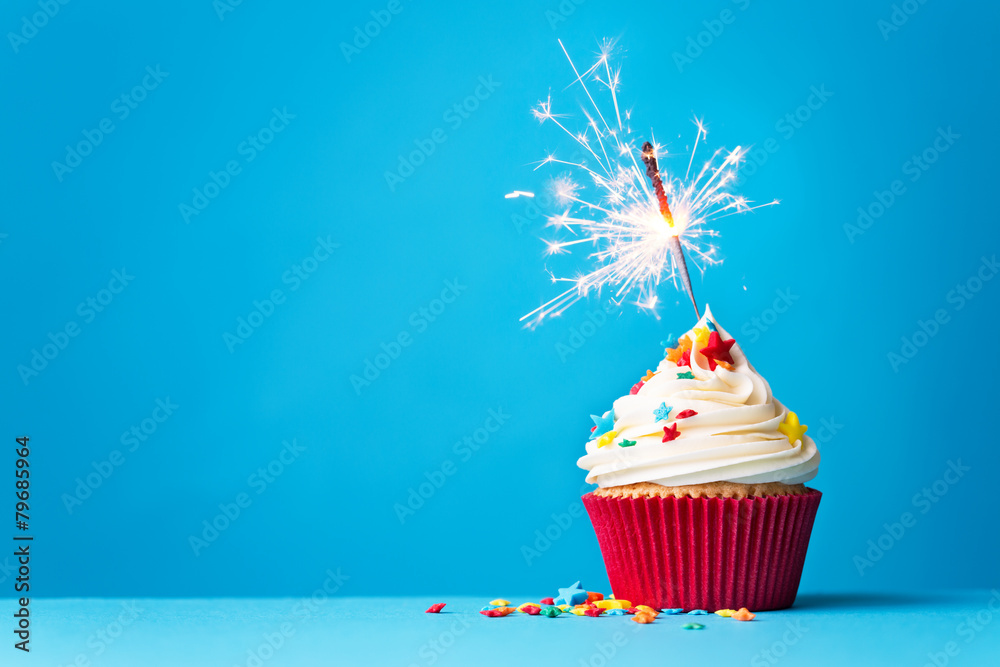 Wall mural cupcake with sparkler on blue