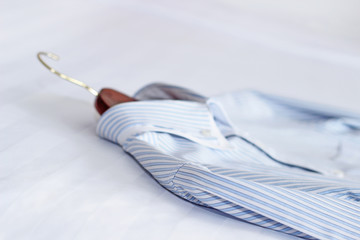 Men's classic shirts on the bed. Shallow depth of field - 79685937