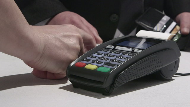 Person using credit card processing terminal in Ukraine