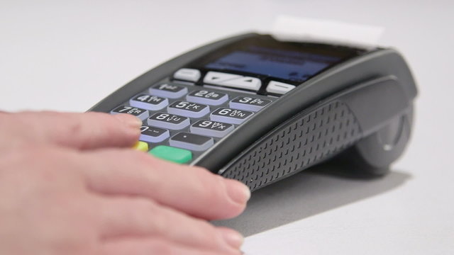 Swiping card through credit card terminal and printing receipt