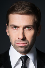 Studio portrait of thinking young business man. In thought. Suit