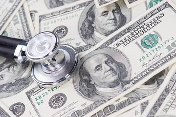 Stethoscope on one hundred US dollar bills.
