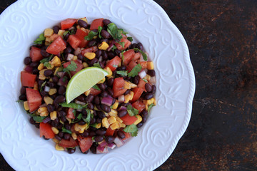 Black bean salad in white plate