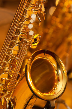 Fragment of the saxophone in golden tones