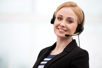 Young call center female operator with headphones