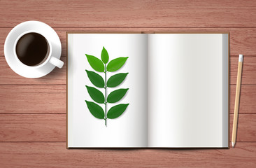 green leaf an open  Sketchbook  with Pencil and a Cup of Coffee