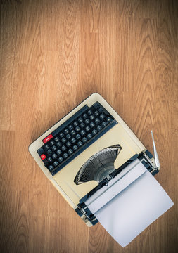 Vintage typewriter and a blank sheet of paper