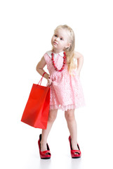 Funny little girl trying on mother's accessories and shoes