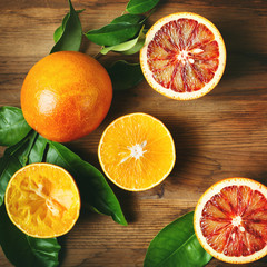 Different sort of orange fruit on wooden table