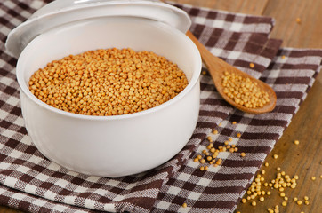 Mustard seeds in  white bowl.