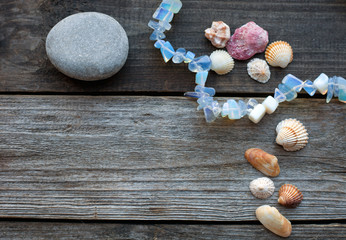 seashells and pebbles on the wooden table