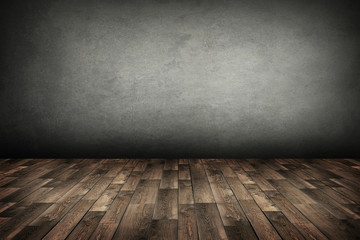 old room with concrete wall and wooden floor