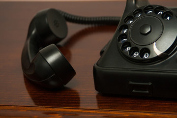 Old retro black telephone on desk