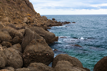 big stone rock over the sea water