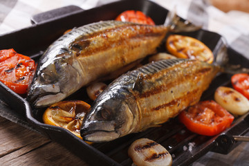 delicious grilled sea fish and vegetables in a pan grill