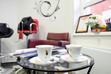 Two white cups on the glass table
