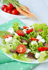 salad with chicken liver. cherry tomatoes and feta cheese