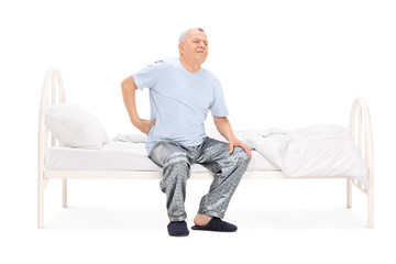 Fototapeta premium Senior waking up with a pain in his back
