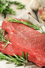 Raw beef steak with rosemary and garlic