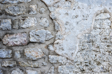 Old rough grey stone wall texture