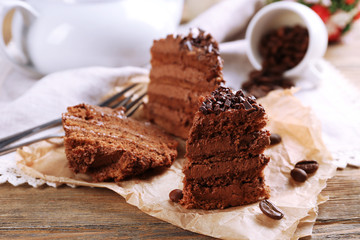 Slices of tasty chocolate cake on plate on table close up